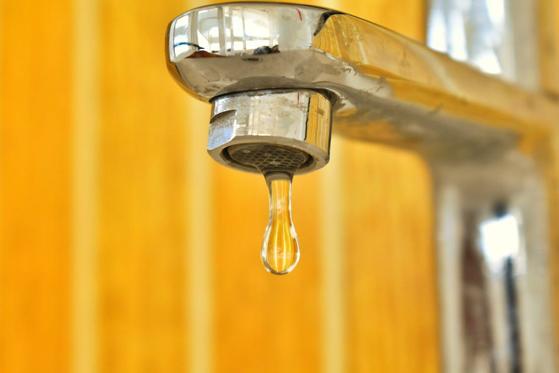 Close-up of a dripping faucet in need of repair by Spokane, WA plumbers.