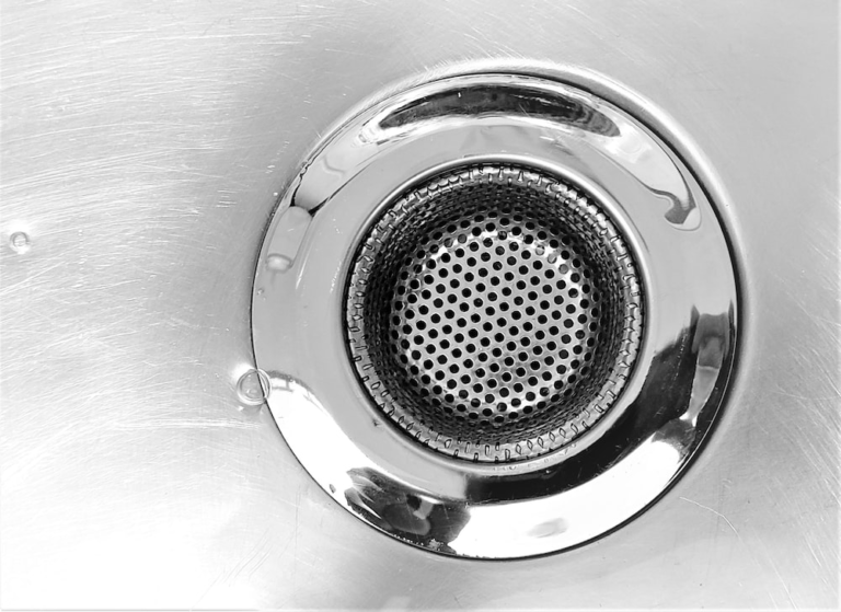 Close-up of a chrome sink drain strainer.