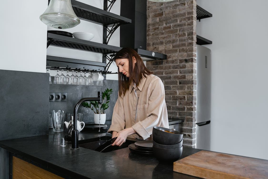 a woman washing dishes.