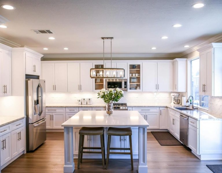 Remodeled kitchen in Spokane, WA with a white island and pendant lighting.