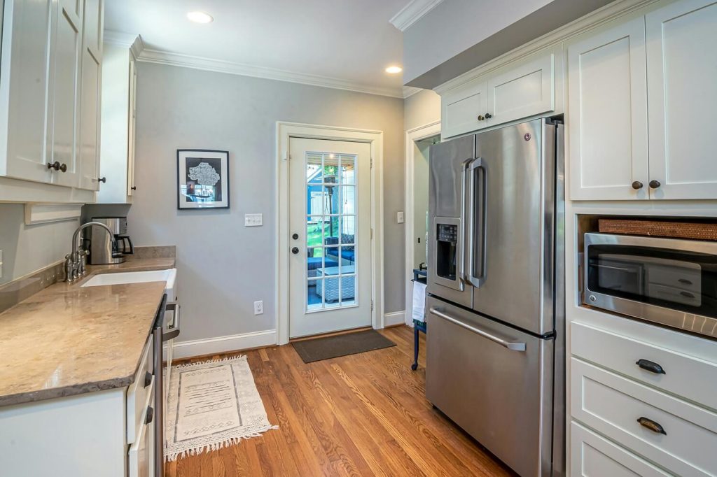 Kitchen and hallway renovation with white cabinetry in the Spokane, WA area.