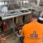 action craft experts spokane wa plumbers repairing a sink in a commercial space