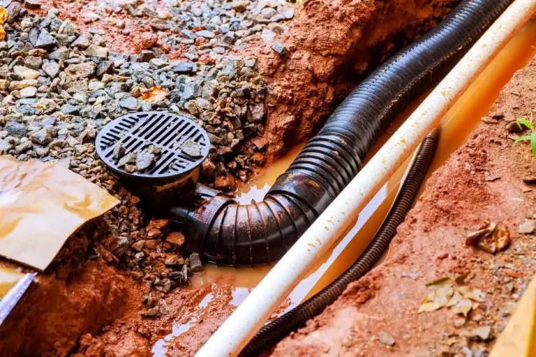 Drainage trench with pipe installation for underground utility work.
