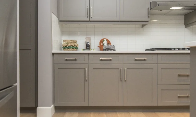 Modern kitchen with gray cabinetry and a range.