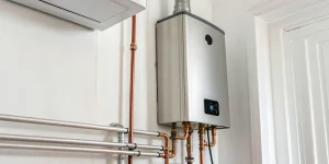 An installed electric tankless water heater, showing how to connect the plumbing and electrical lines.