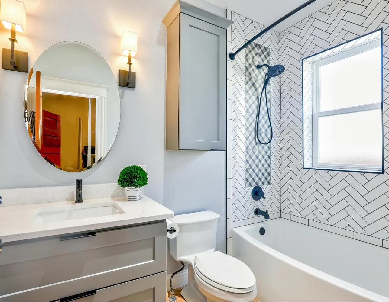 Remodeled bathroom with new vanity and glass shower by a Spokane, WA plumbing contractor.